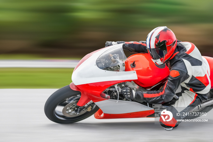 Motorcycle practice leaning into a fast corner on track