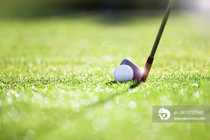 Golfer hitting iron club on golf course on fairway.