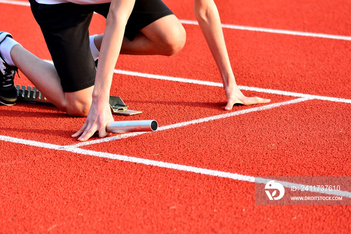 Athlete in the starting blocks for a relay race.