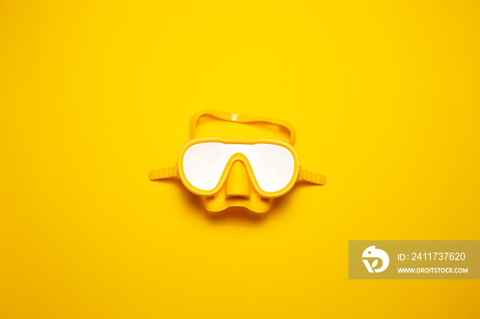 Top view of yellow diving mask isolated on yellow background.