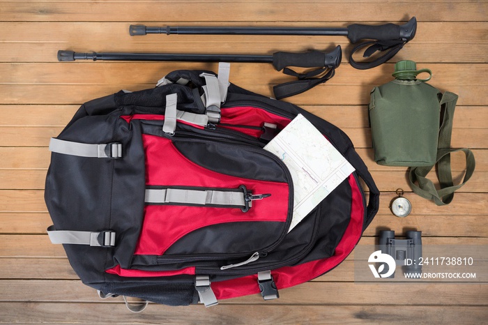 Various travel equipment on wooden floor