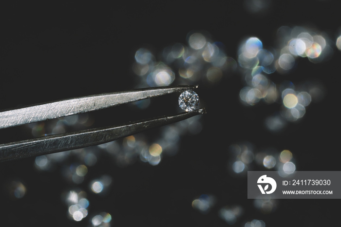 close up photo of round Diamond in Tweezers