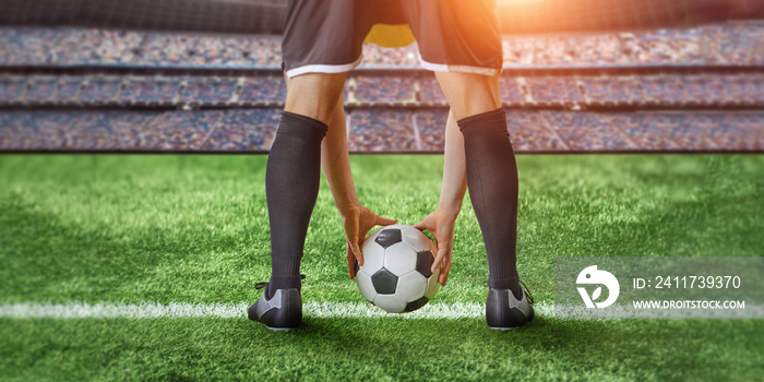 a soccer player prepares a ball to kick off