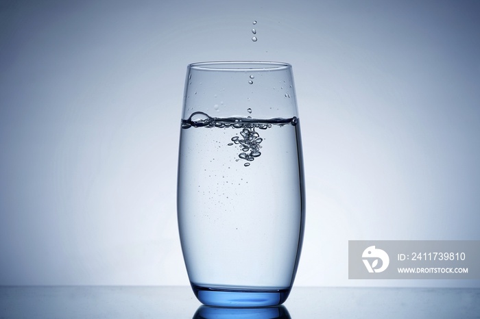 photo pouring water into a glass