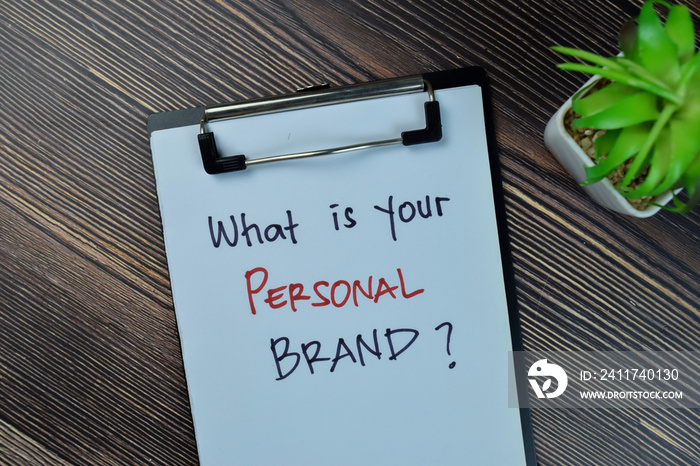 Concept of What is Your Personal Brand? write on a paperwork isolated on Wooden Table.
