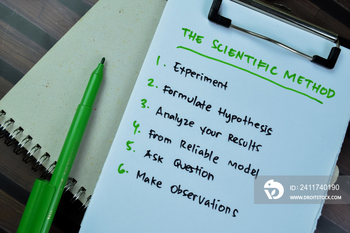 Concept of The Scientific Method write on paperwork isolated on Wooden Table.