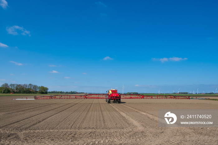 Crop protection by spraying the liquid over the crop in Flevoland with a pulled field sprayer