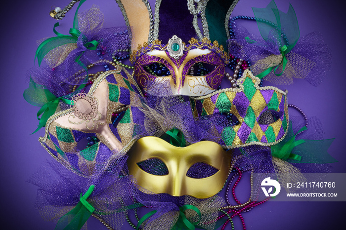 Mardi gras, venetian or carnivale mask on a purple background. Top view