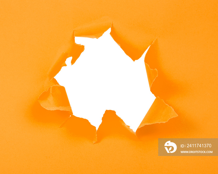 Orange crushed torn paper with hole copyspace background for idea