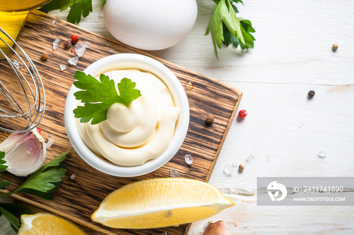 Mayonnaise sauce on white stone table.