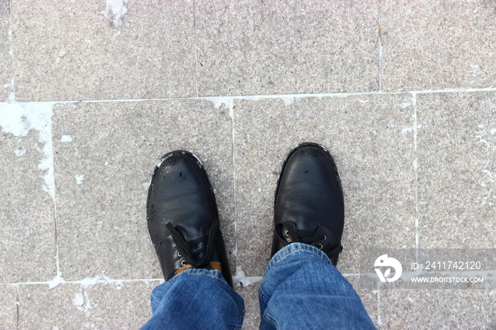 top view of man standing on the granite tile of pavement