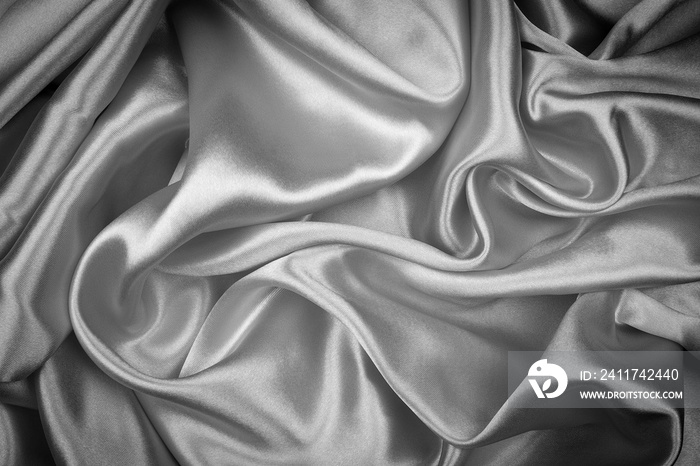 Black silk texture luxurious satin for abstract background. Dark tone