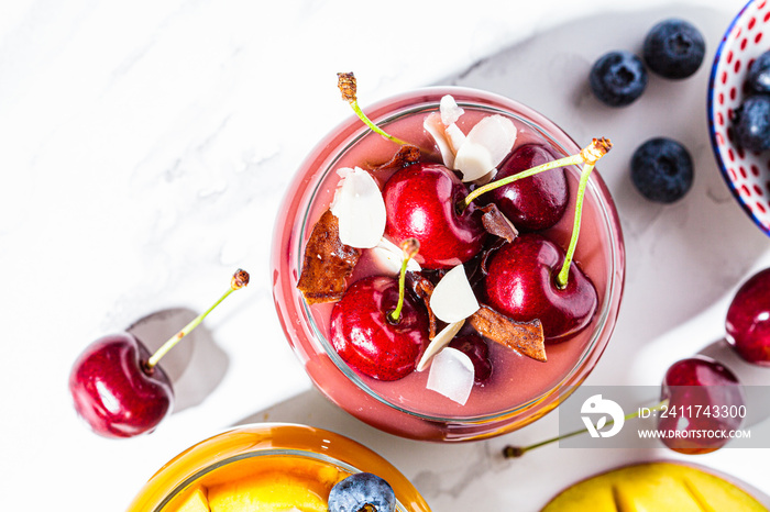 Cherry smoothie in a jar, top view. Healthy food concept, vegan breakfast.