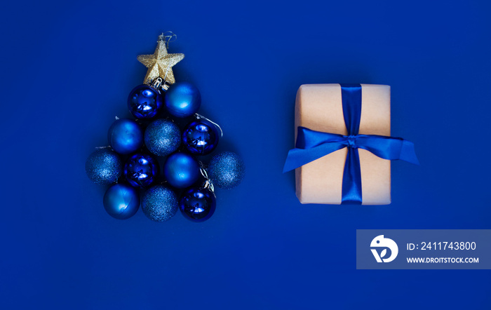 New Year’s gift on a blue background, with a beautiful satin ribbon. Christmas. New Year’s content.