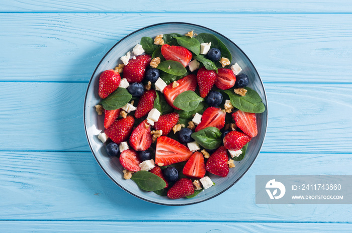 Summer Strawberry salad with spinach , cheese , nuts and blueberry