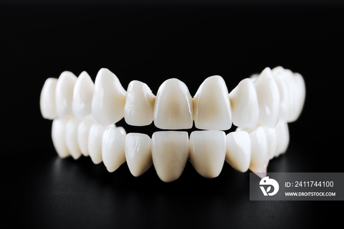 white ceramic teeth isolated on black background