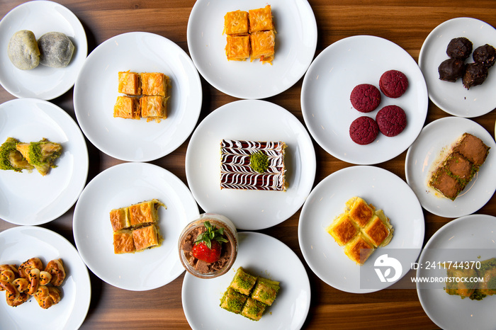 Table scene of assorted take out or delivery foods. Traditional Turkish cuisine. Various Turkish desert and cake. Top down view on a table.