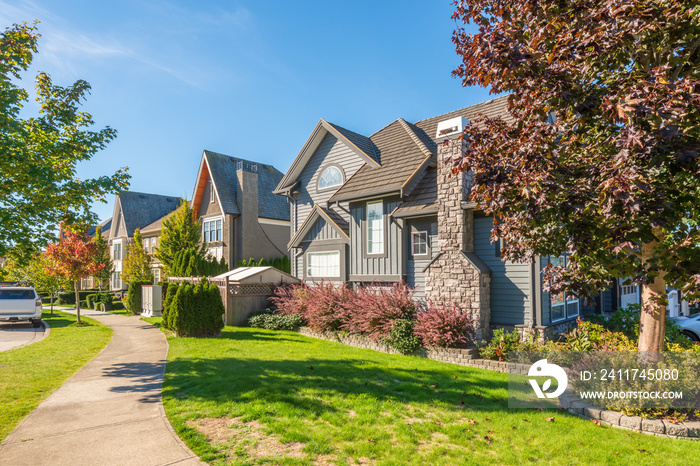 A perfect neighbourhood. Houses in suburb at Summer in the north America. Luxury houses with nice landscape.