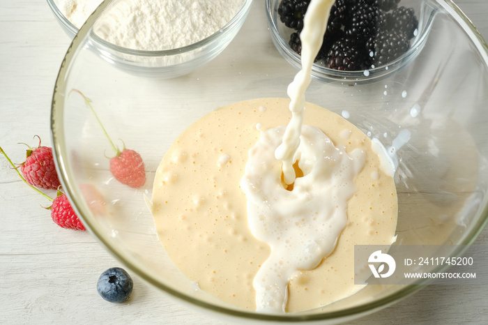 The process of making dough for pancakes.