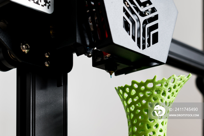 3d printer with a vase printed with pla filament