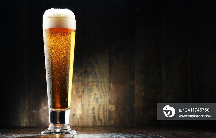 Composition with glass of beer on wooden background