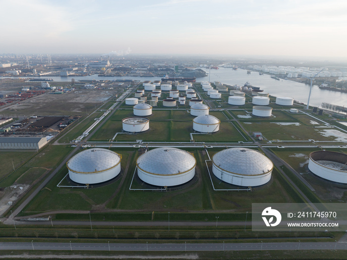 Westpoort commercial petrochemical oil gas fuel storage crude energy silos terminal at large industrial habour. Huge storage of liquid aerial drone view in the port of Amsterdam, The Netherlands.