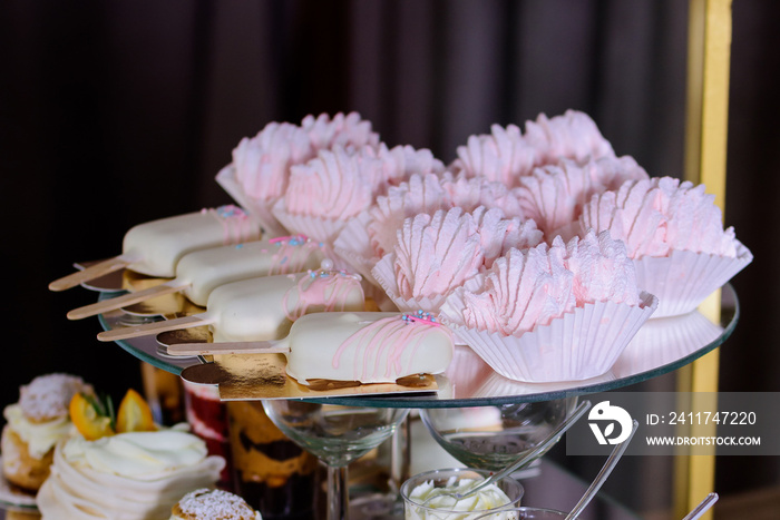 Delicious pink sweets on candy bar.