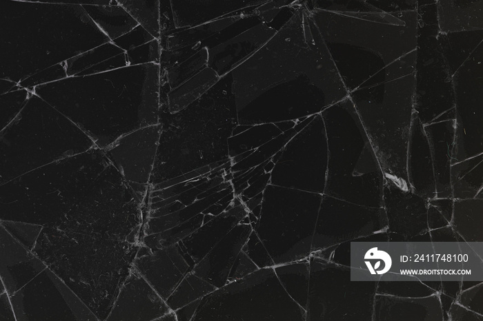 Black cracked glass texture background. Crack on the glass. Broken screen. Broken dark phone.  White cracks in glass