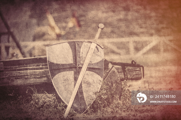 cool metallic sword and heavy shield on the middle ages wagon background