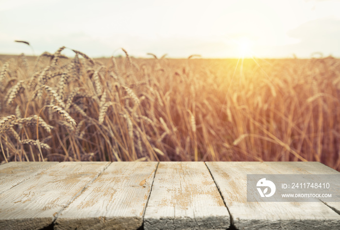 Wheat field with wood planks. Empty tabletop. Table with wheat.Beautiful Nature Sunset Landscape. Rural Scenery with golden wheat. Agriculture background with Harvest