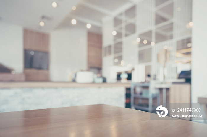 Wood table and blurred coffee shop interior background and lighting bokeh