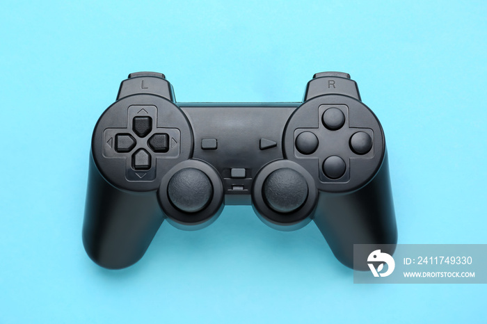 Modern game pad on color background