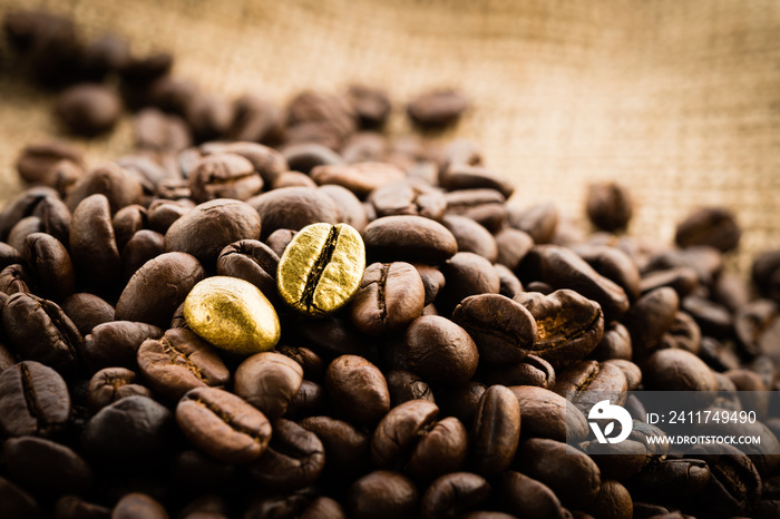 Gold coffee beans on a pile of coffee beans. The concept of luxury is extraordinary.