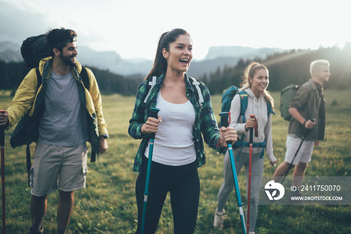 Adventure, travel, tourism, hike and people concept - group of smiling friends with backpacks and map outdoors