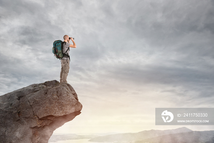 Explorer on the peak of a mountain