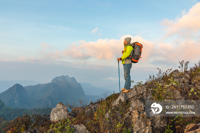 Hiker with backpack standing on top mountain sunset background. Hiker men’s hiking living healthy active lifestyle.