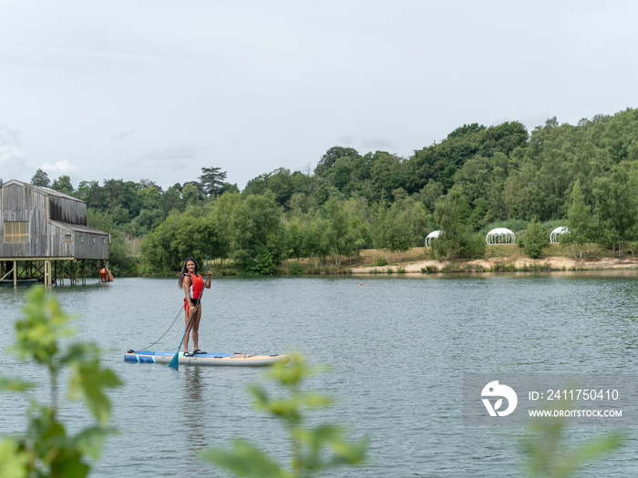 Woman paddleboarding on lake