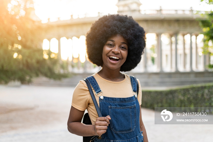 african american woman backpacker traveler, tourist in city, happy smiling, at sunset