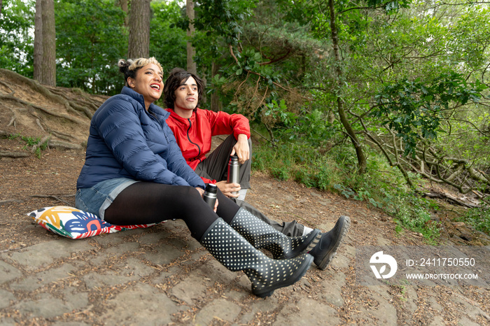 Mother and son relaxing in forest