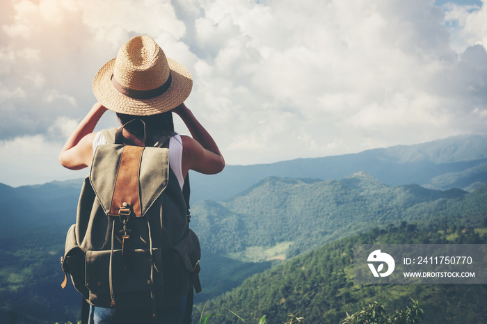 Woman with Binoculars and Telescope in Rain Forest.Travel concept.