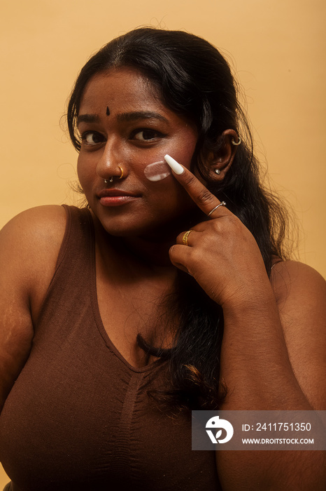 South Asian female solo lifestyle studio portrait skin care shot