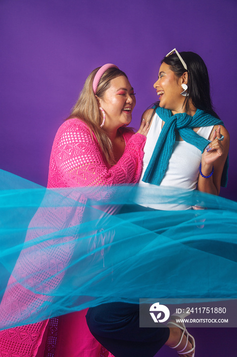 Asian duo fashion colour-blocked studio portrait