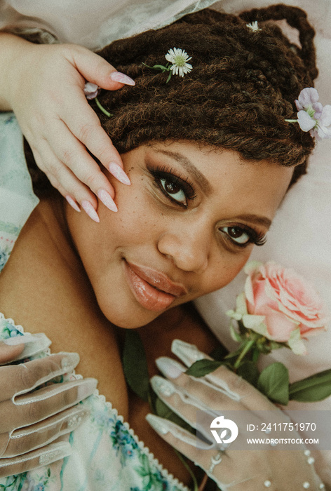 close up portrait of a plus size black woman with a hand on face