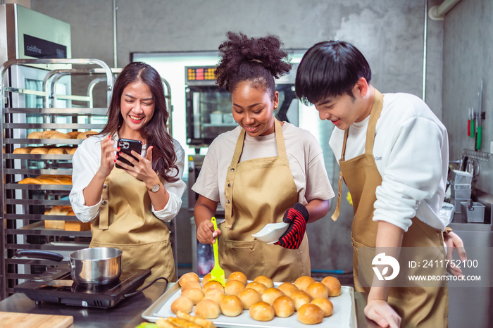 Students In Cookery Class Mixing Ingredients For Recipe In Kitchen.Group of young people taking selfie during cooking classes.