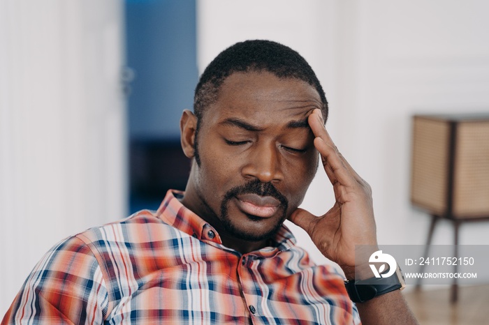 Face of tired online teacher which closed his eyes and touches head. Overwork concept.