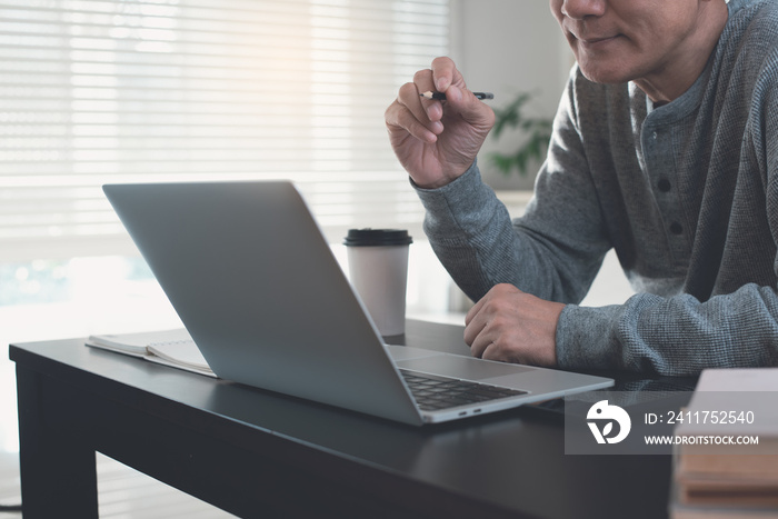 Work from home, E-learning, online meeting concept. Man working on laptop computer, making facetime video call at home