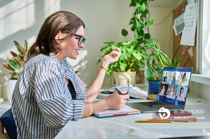 Female teacher working at home, online lesson with group of teenage students