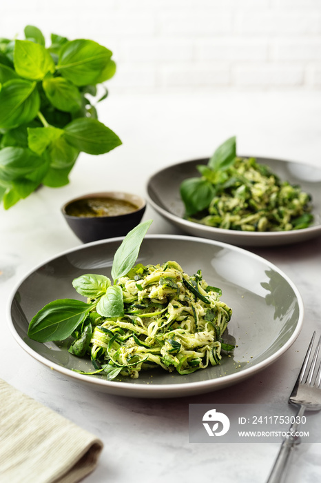Zucchini vegan pasta on white background. Vegetarian healthy food