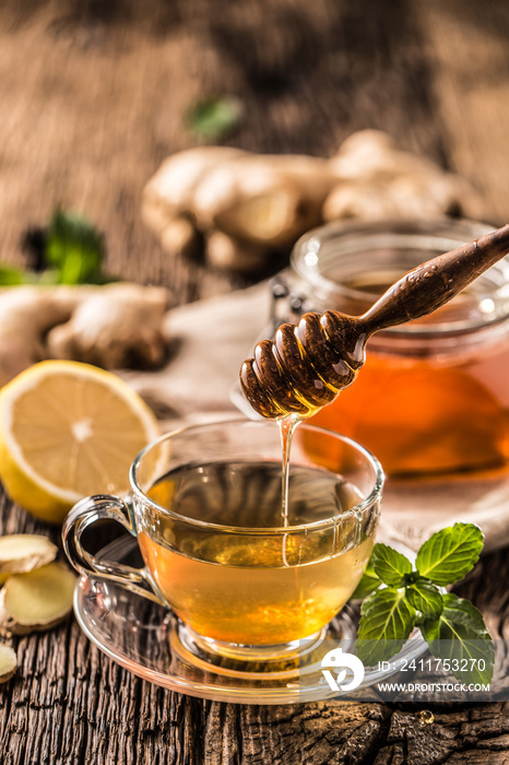 Ginger tea honey lemon and mint leaves on wooden table