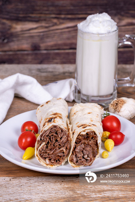 Wrap Doner Kebab. Meat doner kebab on wooden background. Traditional Turkish cuisine. Close-up. local name durum et doner